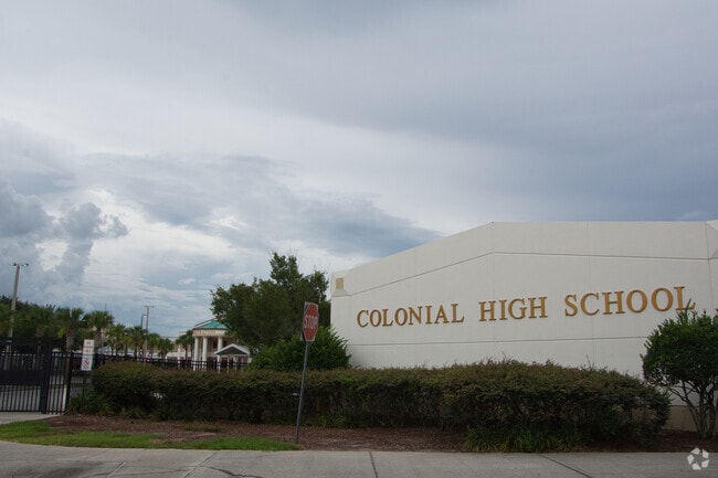 A secured gate controls entry to Colonial High School.