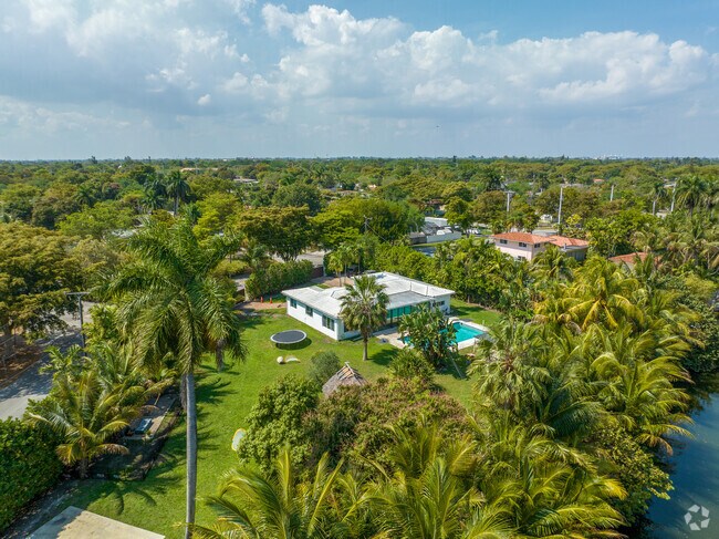 A villa-style house with an in-ground pool sits along the Breezeswept Border waterway.