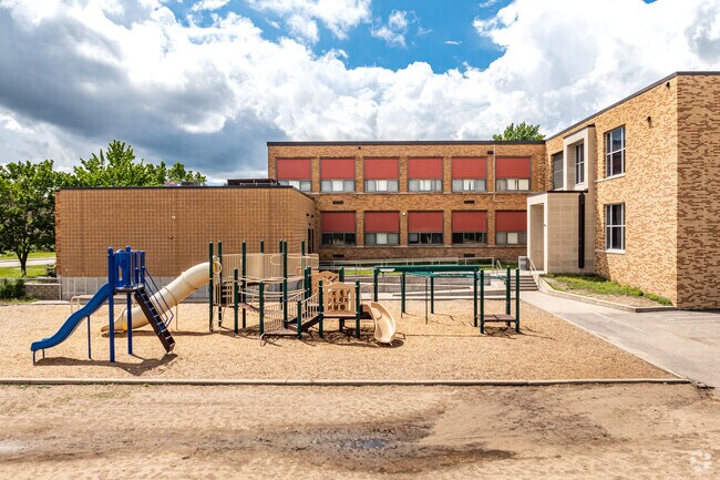 Lincoln Elementary School for the Arts features a large play area behind the school.