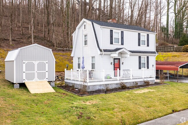 A Dutch Colonial home sits on a quiet, heavily wooded lot in Sycamore Shoals.
