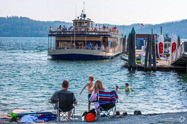Watch from the beach as passengers disembark from a tugboat pleasure cruise.