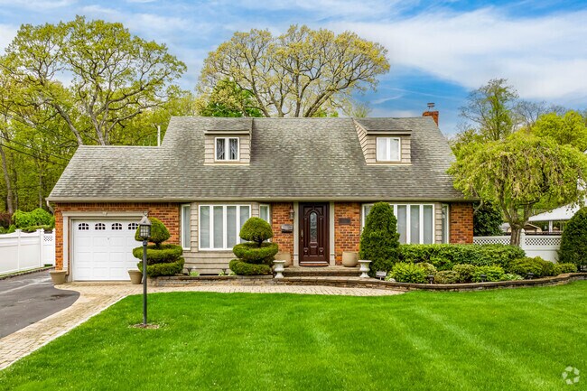 This Cape Cod style home in Commack features two shed dormers and impeccable landscaping.
