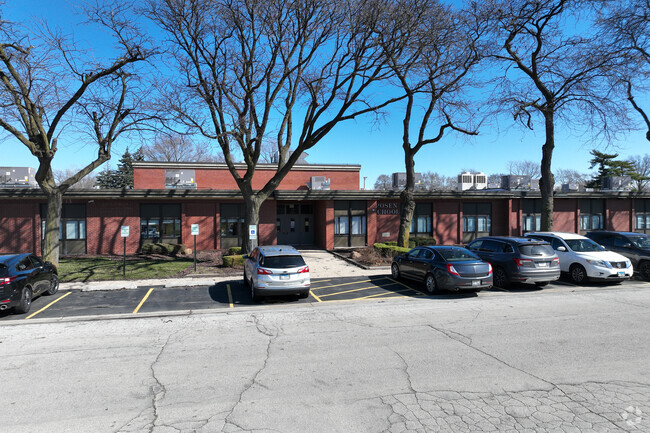 Posen Intermediate School is surrounded by mature trees.