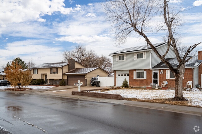 Traditional split-level homes with brick detailing in Laredo Highline in Aurora, Colorado.
