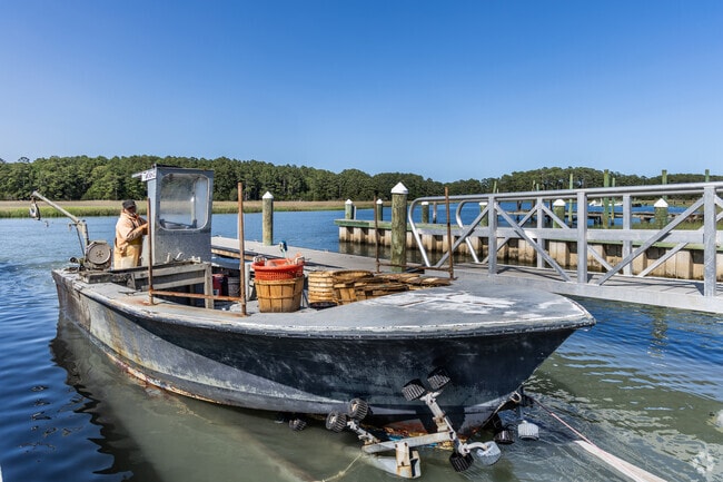 Crab fishermen return to Folly Road’s public dock in Accomac, a favorite local spot for launching boats and hauling in the day’s catch.