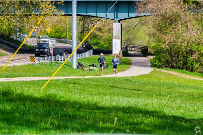 Joggers run along Bandemer Nature Area, located near Barton Hills.