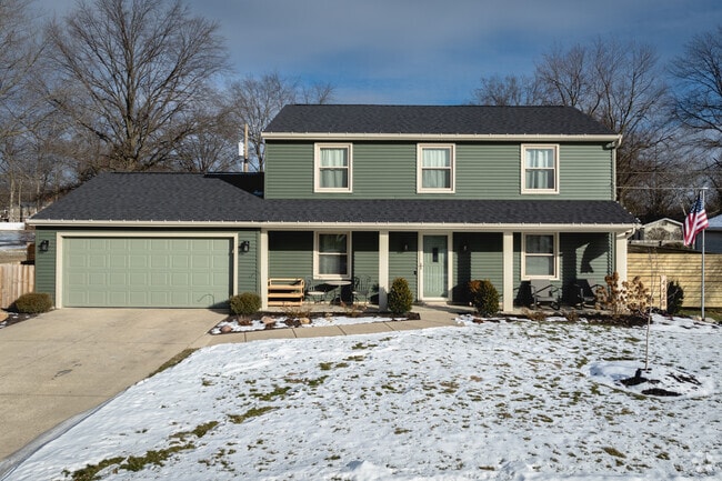 This colorful home features a covered front porch in Imperial Gardens.