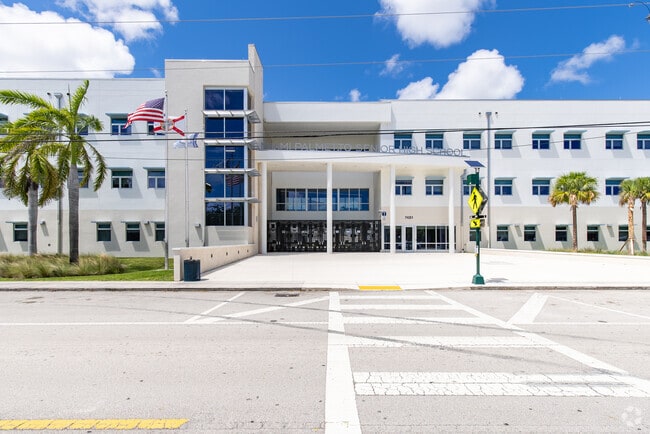 Miami Palmetto Senior High School is bright white with palm trees throughout campus.