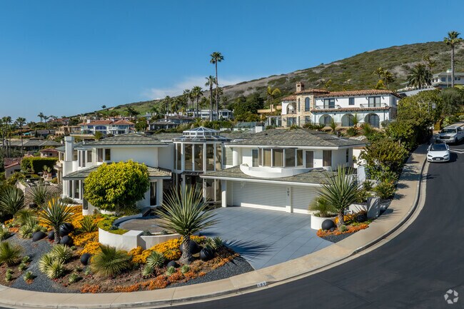 Living in Emerald Bay offers not only luxury and comfort but also an unparalleled connection to nature, with easy access to the beach and a unique sense of tranquility amid the hilly seaside terrain.