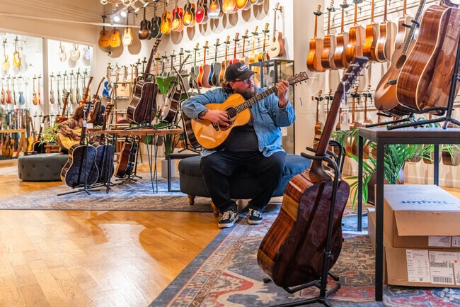 Customers at the Chicago Music Exchange enjoy testing out guitars.