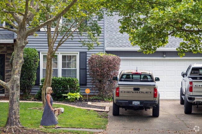 Dog walkers enjoy quiet sidewalks in Virginia Beach’s Bayside neighborhood.