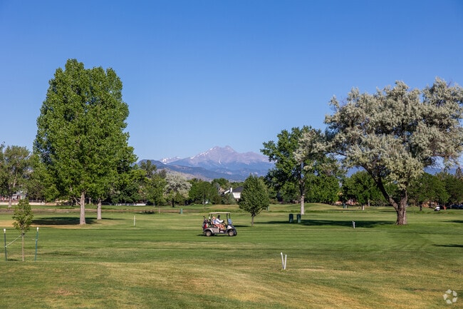 A golf cart glides along the fairways of City of Longmont Twin Peaks Golf Course.