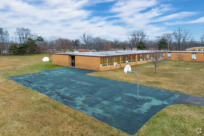 There is a basketball court and baseball field at Neil Reid High School.
