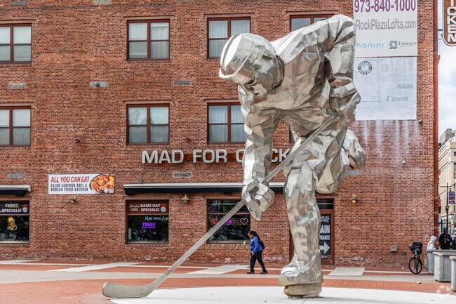 The Iron Man, a giant hockey player sculpture, honors Newark's sports culture.