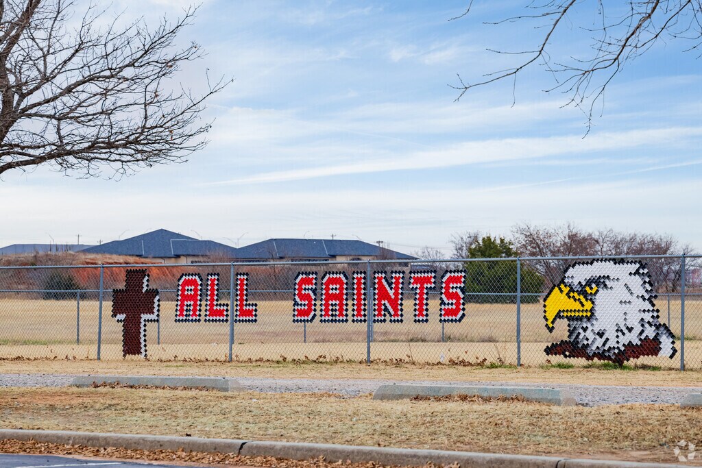 Close up shot of the signage of All Saints Catholic School.