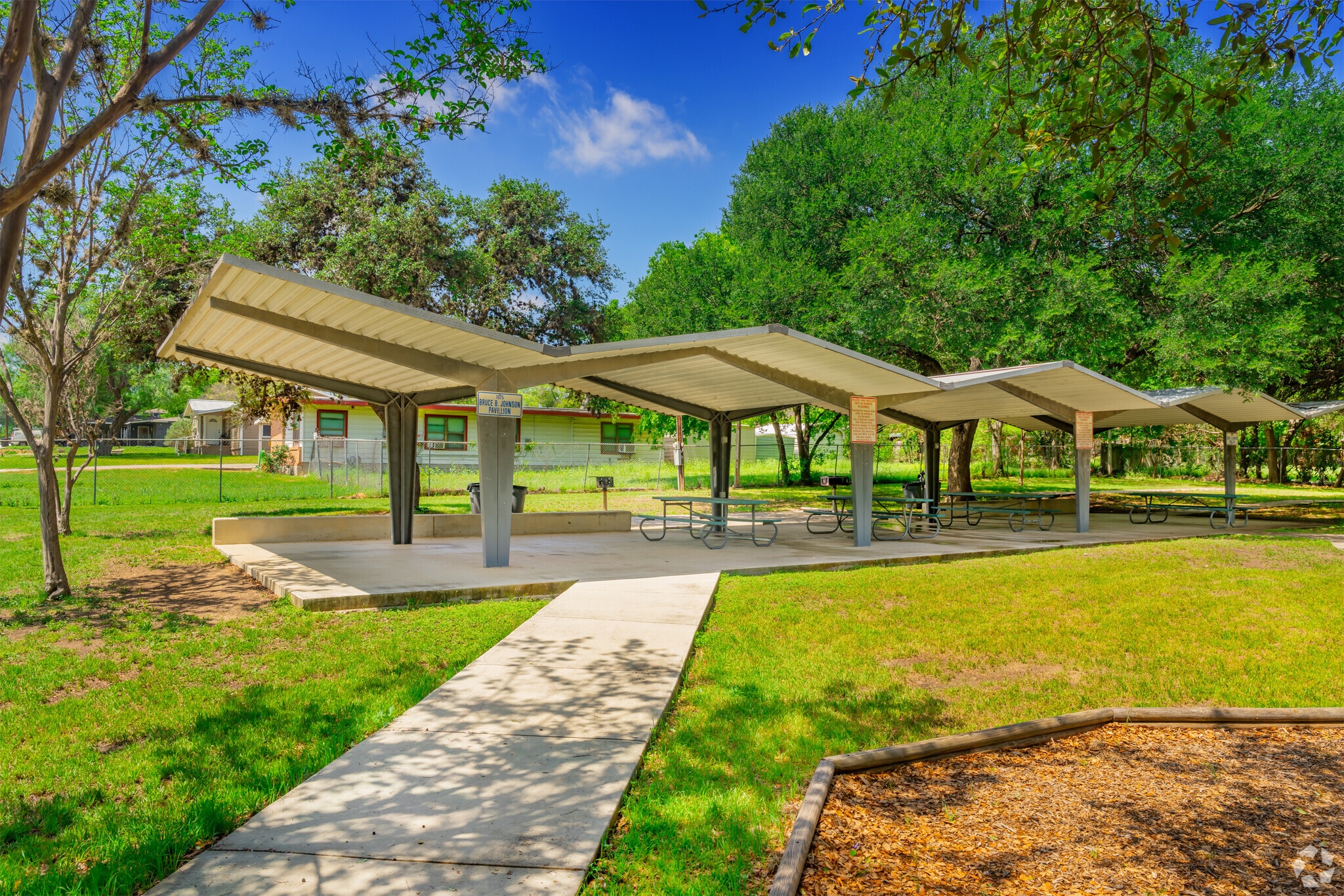 Rogiers Park, in Balcones Heights, has covered tables providing shade for park outings.