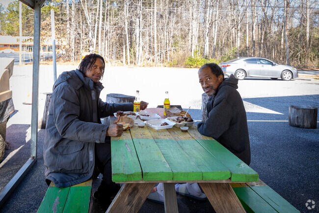 A father and son enjoying a meal at the Scotch Bonnet Jamaican Restaurant.