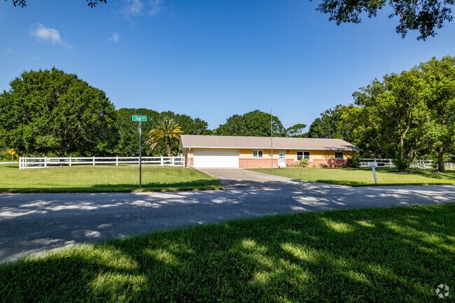 A fenced in ranch-style home in Tomoka Farm