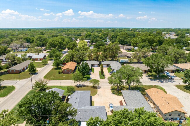 The homes in Indian Hills are surrounded by mature trees.