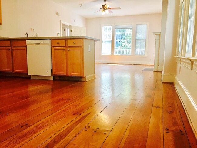 Kitchen with modern appliances, natural light, and open flow to dining and living.