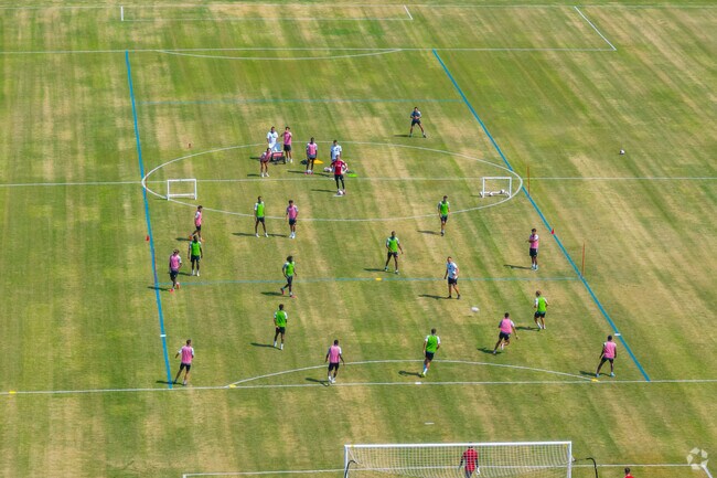 Locals play a game of soccer during the summer in John Hunt Park in Huntsville.