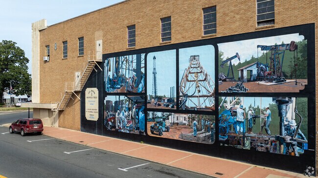 A mural in downtown Magnolia depicts the areas history of the oil industry in the area.