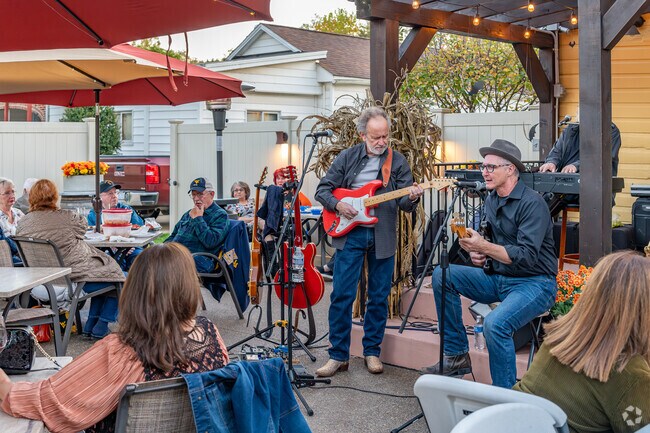 Locals enjoy live music while tasting wines at Vino di Piccin Winery & Tasting House in Lansing.