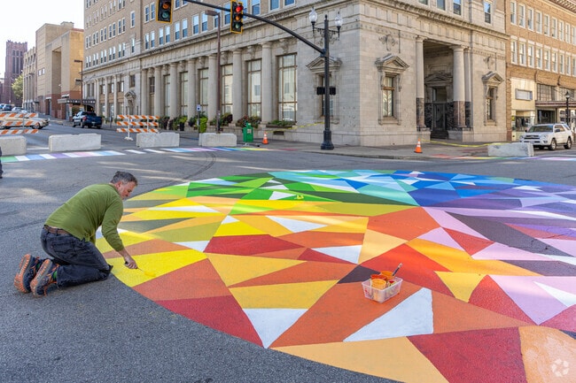 Volunteer artists revamp artwork in Downtown Huntington.