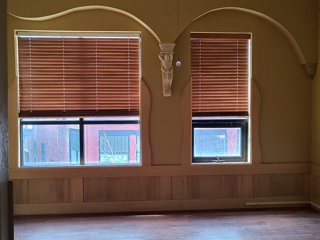 Oversized windows overlooking 5th Avenue in living room.