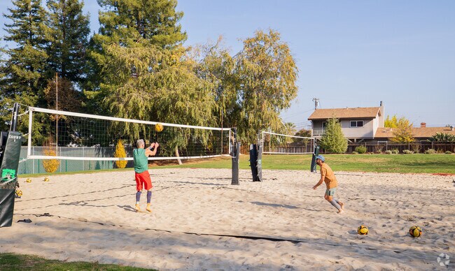 Residents enjoy the local sand volleyball courts.