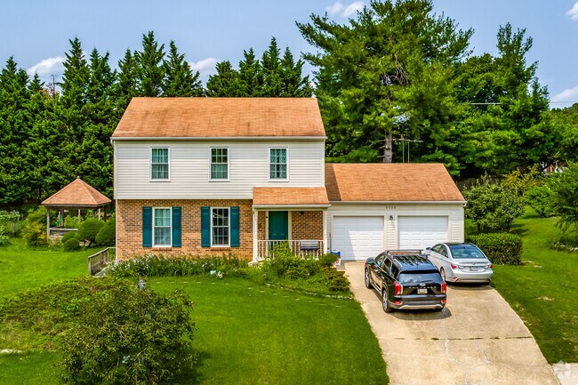 Burtonsville single family home featuring unique landscaping nestled on a hill.