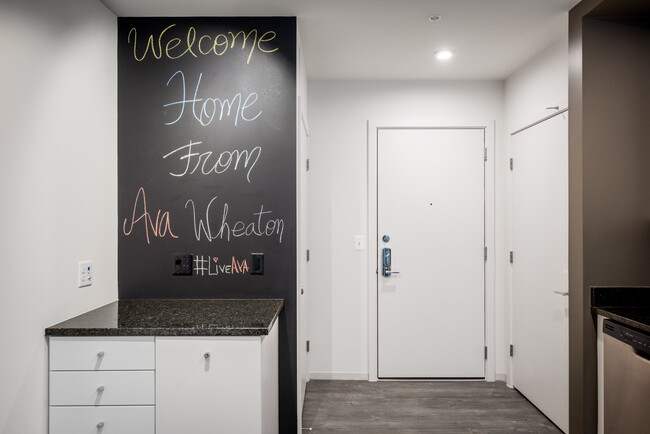 Apartment entry with hard surface flooring and chalkboard wall