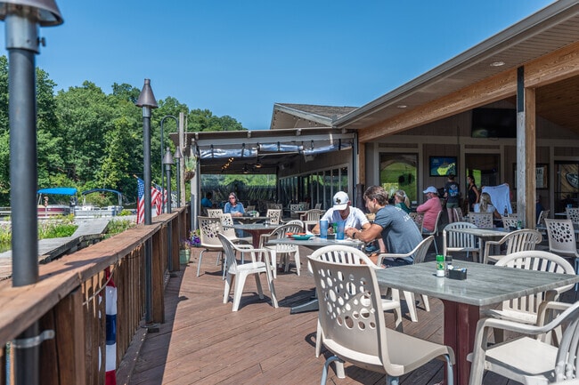 People can enjoy a meal and drinks on the deck at the Lake House Restaurant in Cheat Lake.