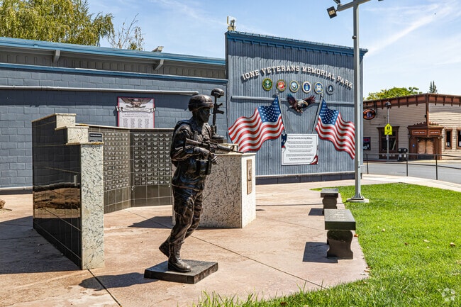 Lone Veterans Memorial Park honors local service members with a statue and tribute wall.
