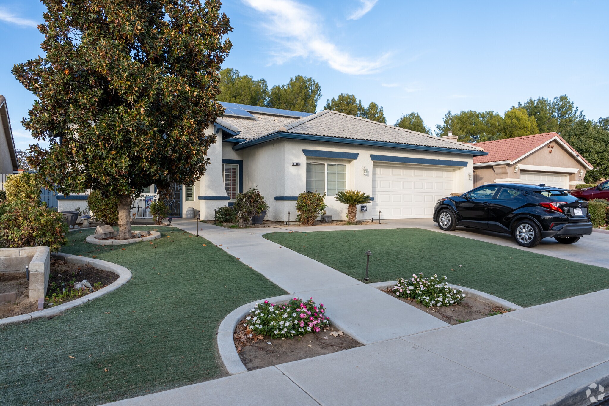 A home with artificial grass in the front yard in River Oaks.