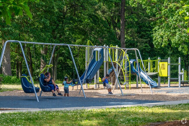 Children use the swings at the Van Horn Park Playground in Liberty Heights.