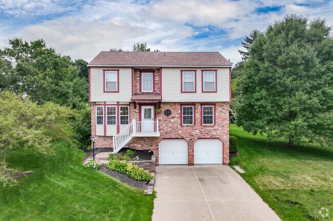 A beautiful red brick home with two door garage in Cranberry Township.