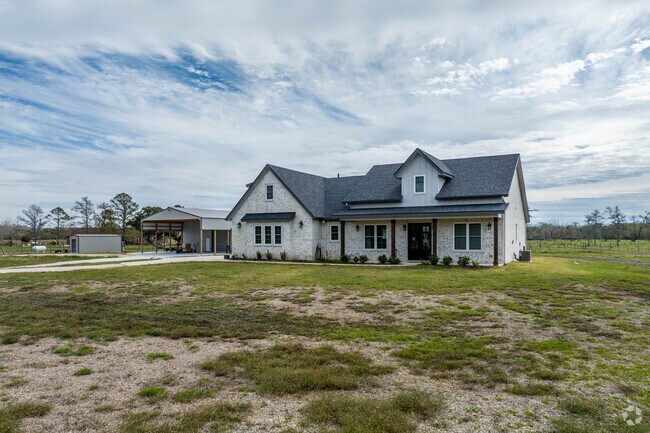 A large two-story home sits on several acres outside Sweeny.