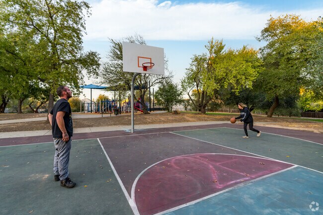 Residents enjoy going to Patriots Park to play basketball in the late afternoon.