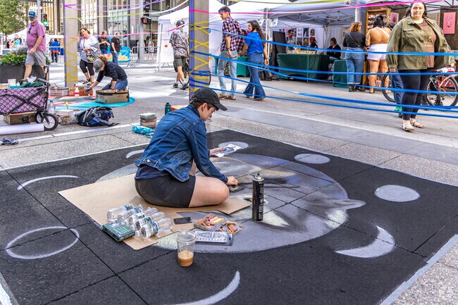 Many artists use a reference photo to create their artwork at the Street Art Festival.