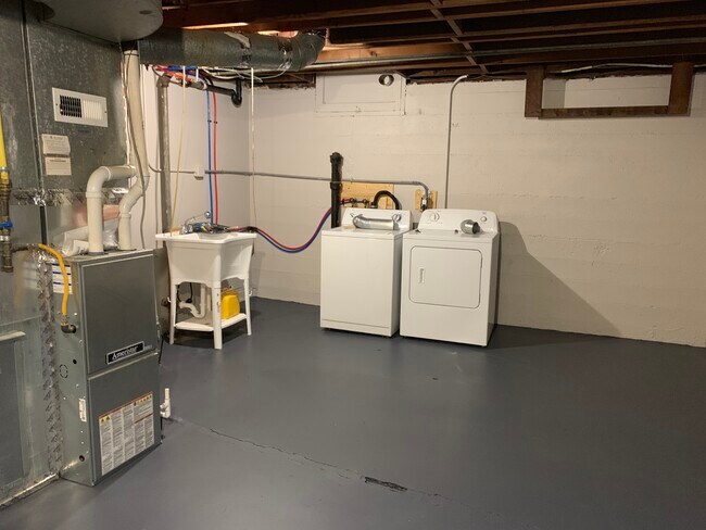 Full basement with washer/dryer and utility sink.