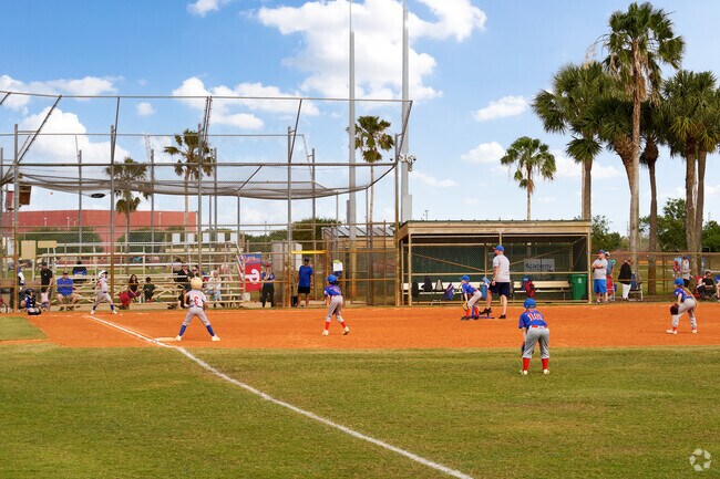 Catch a Little League game near Hidden Oaks at Whispering Pines Park.