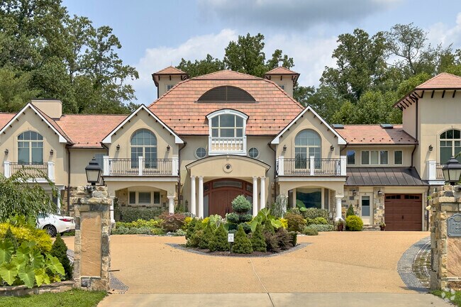 An elaborate custom-made home features a stately entrance in Seven Locks.