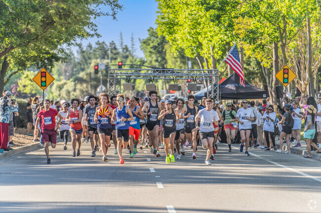 15 minute 5K runners blast out of the start gate at the 4th of July Run in San Ramon, CA.