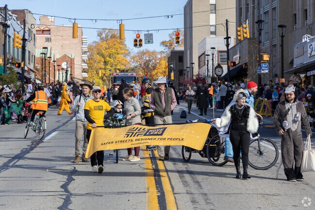 Kids walk the streets during the Pumpkin Patch Parade in there costumes.