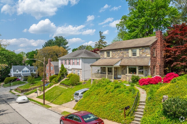 A diverse blend of architectural styles, including Colonial Revival homes with symmetrical facades and stone exteriors, defines Wynnewood’s residential character.