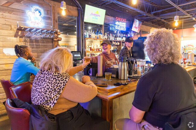 Raise a glass to good times at Shucks Fish House & Oyster Bar near Brook Hollow.