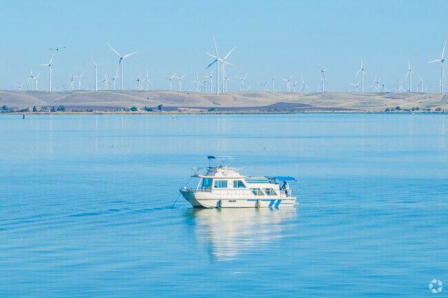 Downtown Pittsburg looks across the bay to massive wind farms that provide clean energy year round.