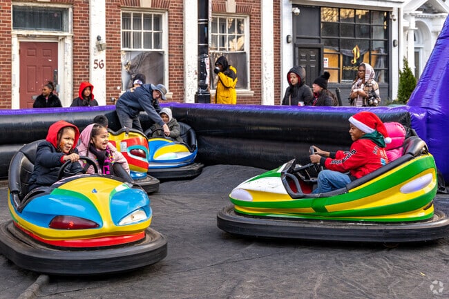 Enjoy go-kart rides with siblings at the Annual Holiday Tree Lighting in Mount Pleasant-Lower Broadway.