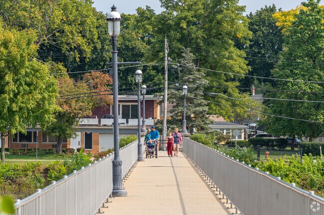 Pedestrians enjoy a stroll across the Fox River from East Dundee to West Dundee.